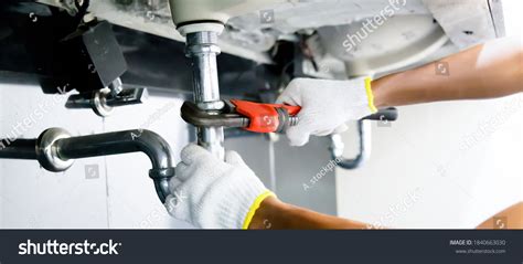 Plumber working on pipes