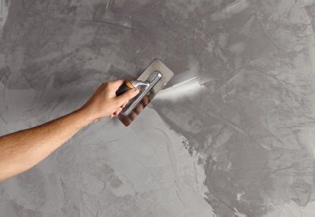 Professionnel appliquant du béton ciré sur un mur